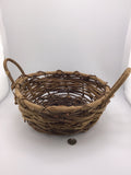 Primitive woven grape vine basket